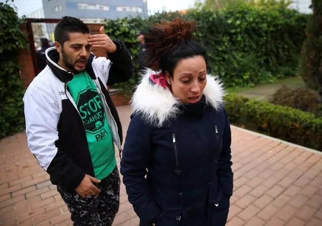 Jose Antonio Rojas Marcos (L), 32, and his wife Jessica Guabala de la Cruz, 28, react after Spanish riot policemen evicted them and their two children, 10 and 3, from their home in Parla, outside Madrid, Spain, November 29, 2016. (Photo by Andrea Comas/Reuters)