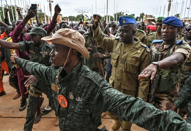 Niger's National Concil for the sefeguard of the Homeland (CNSP) Colonel-Major Amadou Abdramane (2nd R) is greeted by supporters upon his arrival at the Stade General Seyni Kountche in Niamey on August 6, 2023. Thousands of supporters of the military coup in Niger gathered at a Niamey stadium Sunday, when a deadline set by the West African regional bloc ECOWAS to return the deposed President Mohamed Bazoum to power is set to expire, according to AFP journalists. A delegation of members of the ruling National Council for the Safeguard of the Homeland (CNSP) arrived at the 30,000-seat stadium to cheers from supporters, many of whom were drapped in Russian flags and portraits of CNSP leaders. (Photo by AFP Photo/Stringer)