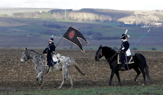 Historical re-enactment enthusiasts dressed as soldiers ride their horses ahead of a re-enactment of Napoleon's famous battle of Austerlitz, that will take place tomorrow, near the southern Moravian village of Herspice, Czech Republic December 2, 2016. (Photo by David W. Cerny/Reuters)