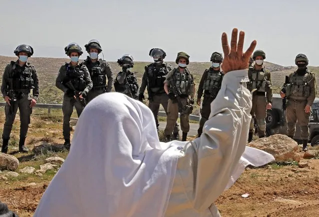 An elderly Palestinian man reacts during a rally protesting the confiscation of land for the Israeli settlement of Karmel, near Yatta village south of Hebron city in the occupied West Bank, on March 19, 2021, before the Israeli army declared the area a closed military zone and ordered demonstrators to leave. (Photo by Hazem Bader/AFP Photo)