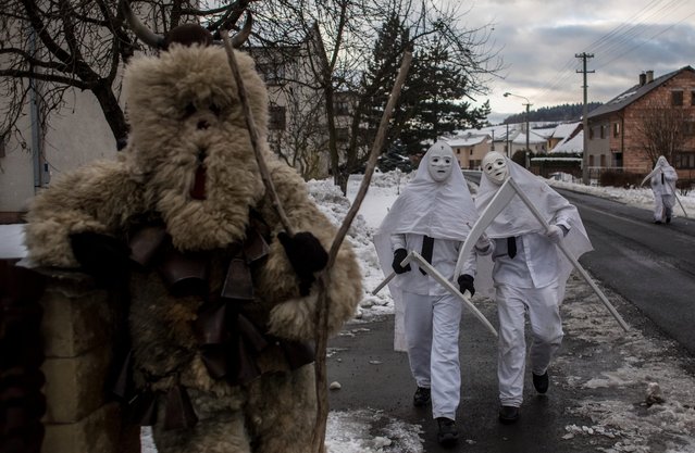 Participants dressed in traditional costumes look like devil and grim reapers walk from house to house during the traditional St. Nicholas parade on December 3, 2016 in village of Francova Lhota, Czech Republic. (Photo by Matej Divizna/Getty Images)