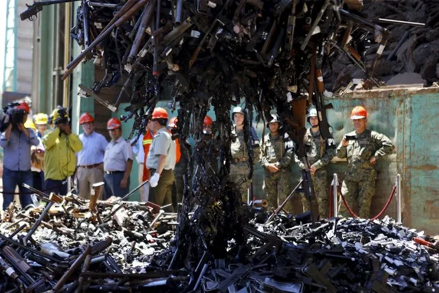 Confiscated weapons hang from a magnet before being destroyed at a foundry in Santiago, Chile, January 18, 2016. (Photo by Ivan Alvarado/Reuters)