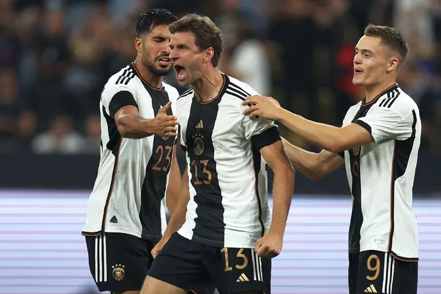 Germany's midfielder #13 Thomas Mueller celebrates scoring the opening goal with his teammates during the friendly football match between Germany and France the Signal Iduna Park stadium in Dortmund, western Germany, on September 12, 2023. (Photo by Franck Fife/AFP Photo)