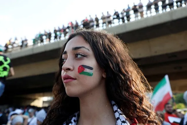 A demonstrator with a Palestinian flag painted on her face takes part in a march to express solidarity with Palestinians in Gaza, in Beirut, Lebanon on October 13, 2023. (Photo by Mohamed Azakir/Reuters)