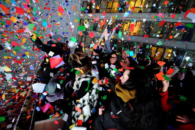 Revelers celebrate as confetti falls just after midnight during New Year celebrations in Times Square in New York, January 1, 2017. (Photo by Mark Kauzlarich/Reuters)