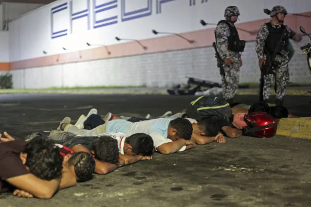 Suspects are detained by navy police after a store was ransacked by a crowd in the port of Veracruz, Mexico, Wednesday January 4, 2017. Protests over a sharp gasoline price hike erupted into looting of gas stations and stores in various parts of Mexico on Wednesday, with dozens of businesses reportedly sacked. In the Gulf coast state of Veracruz, store guards were overrun by crowds who carried off clothing, toys, food, washing machines, televisions, DVD players and refrigerators. (Photo by Felix Marquez/AP Photo)