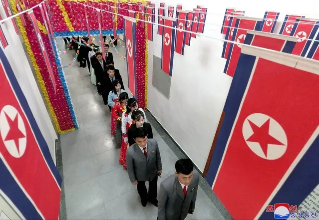 This picture taken on November 26, 2023 and released from North Korea's official Korean Central News Agency (KCNA) on November 27, 2023 shows people lining up to vote during a local election for the provincial and county people's assembly, at an unconfirmed location. North Koreans were urged to vote on November 26 as the country prepares to hold its first nationwide local polls featuring more than one candidate, state media reported. (Photo by KCNA via KNS/AFP Photo)