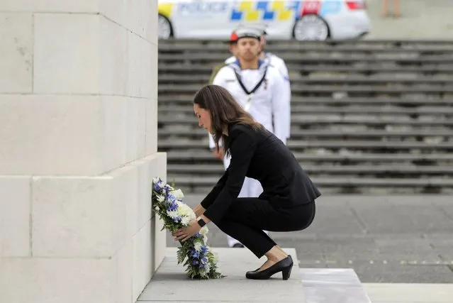 Finland's Prime Minister Sanna Marin, lays a wreath at the cenotaph at the Auckland Museum, in Auckland, New Zealand, Wednesday, November 30, 2022. Marin says it must give more weapons and support to Ukraine to ensure it wins its war against Russia. (Photo by Michael Craig/New Zealand Herald via AP Photo)