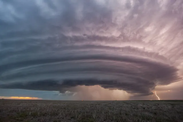 A super cell thunderstorm illuminates the sky, which was formed at about 2pm in the afternoon and was still raging at 10pm at night, in Sanford, Kansas. (Photo by Wiktor Skupinski/Barcroft Media)