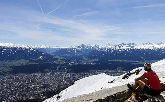 A woman enjoys the view from Seegrube mountain on a sunny spring day in Innsbruck April 15, 2015. (Photo by Dominic Ebenbichler/Reuters)