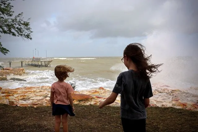 Nyah and Thea watch as the top end storms roll in across Nightcliff beach and Jetty in Darwin, Australia on Wednesday, January 17, 2024. (Photo by Neve Brissenden/AAP Image)