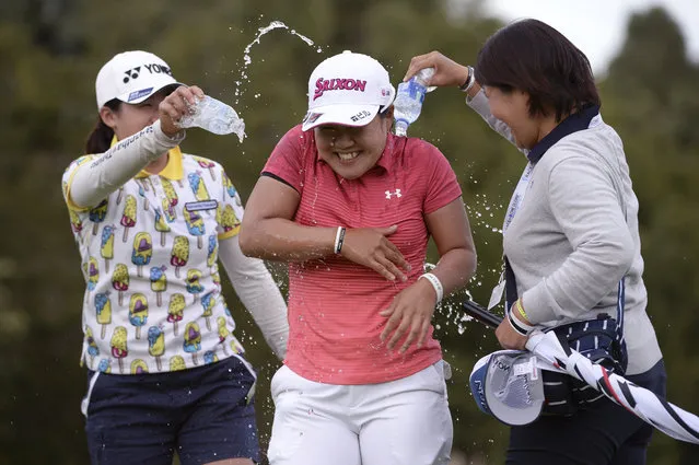 Nasa Hataoka, of Japan, is doused with water by Ayako Uehara, left and her mother, Hiromi,right, after winning the Kia Classic LPGA golf tournament, Sunday, March 31, 2019, in Carlsbad, Calif. (Photo by Orlando Ramirez/AP Photo)