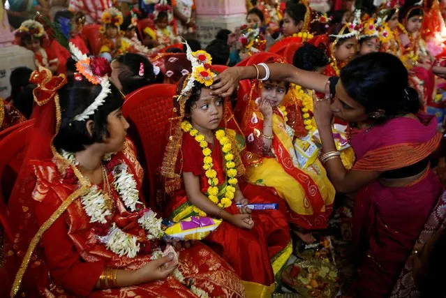 A devotee worships a girl dressed as Kumari during rituals to celebrate the Hindu festival of Navrati inside the Adyapeath temple on the outskirts of Kolkata, India, April 14, 2019. (Photo by Rupak De Chowdhuri/Reuters)