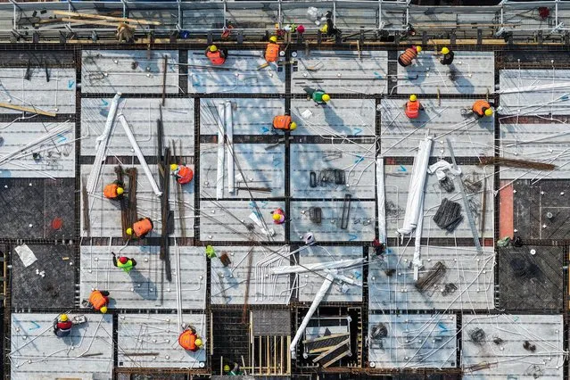 Workers are seen on a rooftop of a residential building under construction in Nanjing, in eastern China's Jiangsu province on March 7, 2024. (Photo by AFP Photo/China Stringer Network)