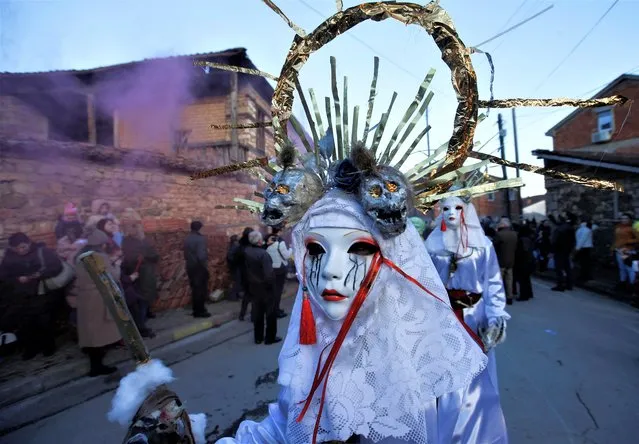 A reveller participates in a parade during a carnival to mark the annual Orthodox St. Vasilij Day, the beginning of the Orthodox New Year, in the village of Vevcani, North Macedonia on January 13, 2023. (Photo by Ognen Teofilovski/Reuters)