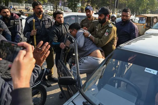 Police detain the supporters of Khan's Pakistan Tehreek-e-Insaf (PTI) party as they protest against the alleged skewing in Pakistan's national election results, near the office of a Returning Officer (RO) in Lahore on February 11, 2024. Pakistan police warned on February 11 they would come down hard on illegal gatherings after the party of jailed former prime minister Imran Khan urged supporters to protest against alleged rigging in last week's election. (Photo by Arif Ali/AFP Photo)
