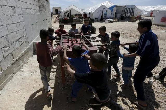 Internally displaced boys play table football inside a refugee camp in Dana town after fleeing Palmyra, in northern Idlib province, Syria April 2, 2016. (Photo by Khalil Ashawi/Reuters)