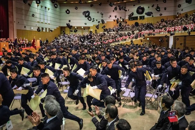 Graduates of the National Defence Academy of Japan leave after tossing their caps in the air during their graduation ceremony in Yokosuka, Kanagawa prefecture on March 23, 2024. (Photo by Yuichi Yamazaki/AFP Photo)