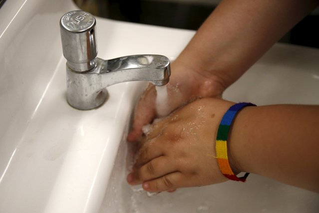 A student washes her hands in the first gender-neutral restroom in the Los Angeles school district at Santee Education Complex high school in Los Angeles, California, U.S., April 18, 2016. (Photo by Lucy Nicholson/Reuters)