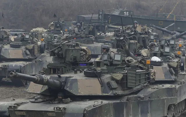 In this December 10, 2015 file photo, U.S. M1A2 SEP Abrams battle tanks prepare to cross the Hantan river during a river crossing operation, part of an annual joint military exercise between South Korea and the United States against a possible attack from North Korea, in Yeoncheon, south of the demilitarized zone that divides the two Koreas, South Korea. China on Wednesday, March 8, 2017 proposed that North Korea could suspend its nuclear and missile activities in exchange for a halt in joint military drills conducted by the U.S. and South Korea. (Photo by Ahn Young-joon/AP Photo)