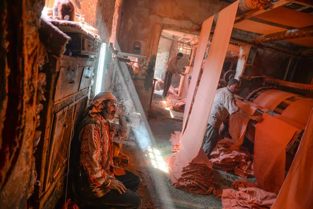 A picture made available on 20 April 2016 shows the workers preparing the dried dyed fabrics in order to be cut into standard sizes before selling them, at a workshop in al-Moez street at al-Hussein district in Old Cairo, Egypt, 14 April 2016. The craft of dyeing fabrics is one of the oldest hand crafts in Egypt and can be dated to the early days of ancient Pharaonic Egypt. (Photo by Mohamed Hossam/EPA)