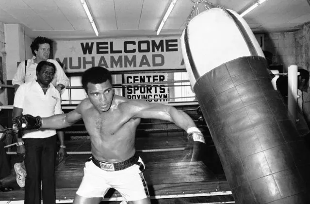 In this Wednesday, June 23, 1976 file photo, Muhammad Ali throws a left punch at a sandbag during workout at a gym in Tokyo. Later in the week, the world heavyweight boxing champion met Japanese pro wrestler Antonio Inoki in the world's Martial Arts Championship. (Photo by Nick Ut/AP Photo)