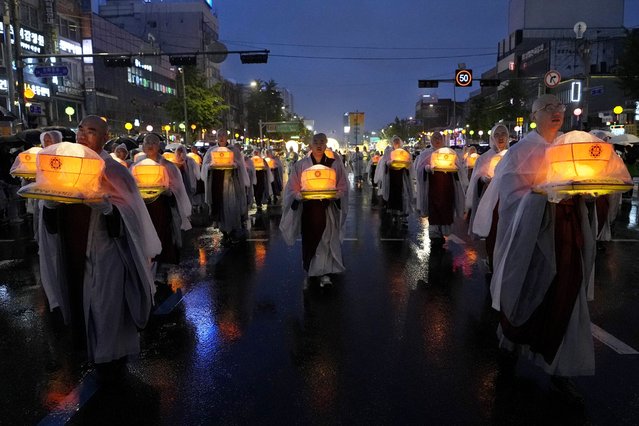 Buddhist monks walk in a lantern parade during the Lotus Lantern Festival, ahead of the birthday of Buddha at Dongguk University in Seoul, South Korea, Saturday, May 11, 2024. (Photo by Ahn Young-joon/AP Photo)