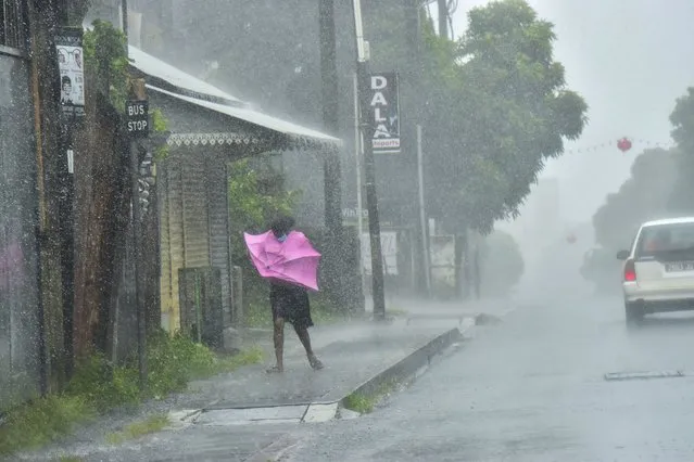 A woman fights Gale force winds in the Indian Ocean Island of Mauritius Wednesday February 2, 2022. Forecasts say Tropical Cyclone Batsirai is increasing in intensity and is expected to pass north of the Indian Ocean island nation of Mauritius on Wednesday evening and make landfall in central Madagascar on Saturday afternoon.The Global Disaster Alert and Coordination System says Batsirai has been upgraded and classified as Category 4. (Photo by Beekash Roopun/L'express Maurice via AP Photo)