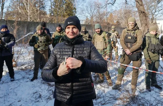 A participant learns to throw a grenade during a military exercise for civilians conducted by members of the Georgian National Legion paramilitary volunteer unit amid threat of Russian invasion in Kyiv, Ukraine on February 4, 2022. (Photo by Serhii Nuzhnenko/Reuters)