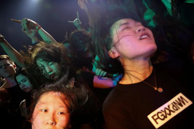 Fans enjoy the band called Suffocated performing on the stage of Mao Live House during the club's last public concert night in central Beijing, China April 24, 2016. (Photo by Damir Sagolj/Reuters)