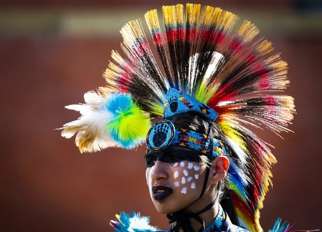 A member of the Stoney First Nation wears a headdress during the Calgary Stampede parade in Calgary, Alberta, Friday, July 3, 2015. (Photo by Jeff McIntosh/The Canadian Press via AP Photo)