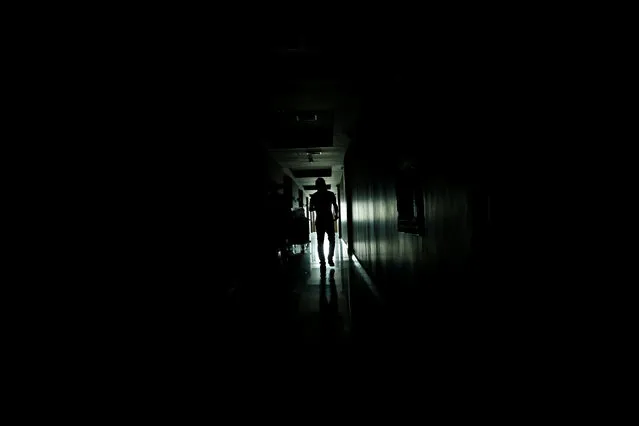 A man walks in the hallway of a hotel, during a power cut in Barinas in the state of Barinas, Venezuela, March 30, 2016. (Photo by Carlos Garcia Rawlins/Reuters)