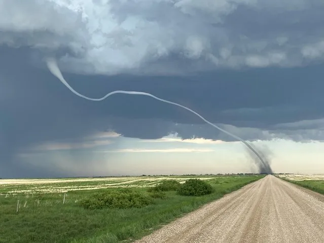 A tornado makes an impression over fields in D’Arcy, Saskatchewan, Canada on June 15, 2021. (Photo by Neil Serfas/Reuters)