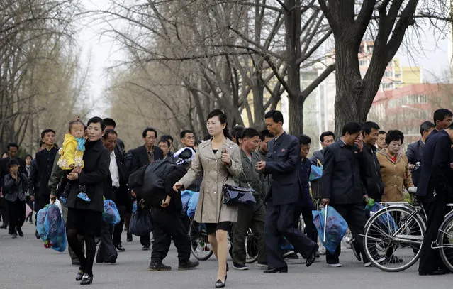 North Korean men and women leave an assembly area after rehearsals for celebrations ahead of the April 15 “Day of the Sun”, a national holiday marking the birthday of the late Kim Il Sung, leader Kim Jong Un's grandfather and North Korea's “eternal president”, Monday, April 10, 2017, in Pyongyang, North Korea. (Photo by Wong Maye-E/AP Photo)