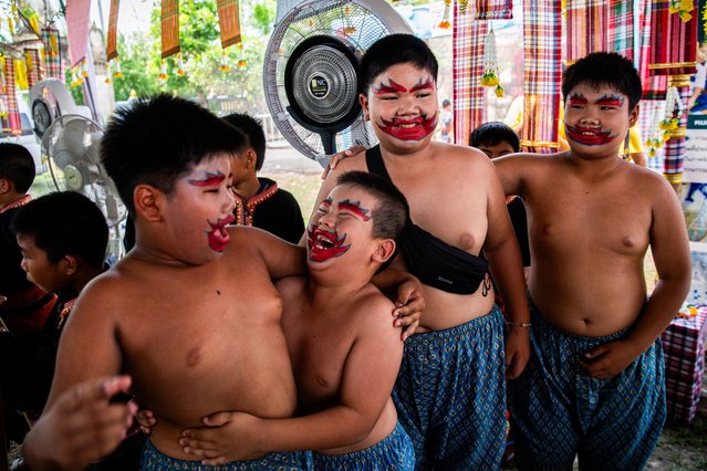 Young Thai boys wear face paint and laugh before a performance at Wat Chai Sri during a Songkran celebration on April 15, 2024 in Khon Kaen, Thailand. Songkran, the traditional Thai New Year's Festival, is celebrated each April, Thailand's hottest month of the year. During Songkran, locals and tourists celebrate by partaking in water fights throughout the country. (Photo by Lauren DeCicca/Getty Images)