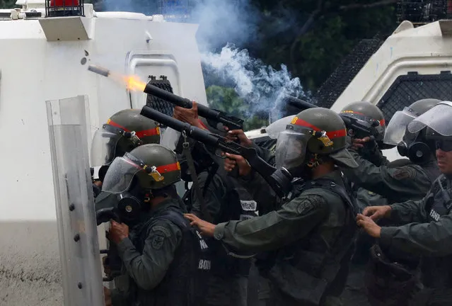 Riot police fire tear gas while clashing with opposition supporters rallying against President Nicolas Maduro in Caracas, Venezuela May 3, 2017. (Photo by Carlos Garcia Rawlins/Reuters)