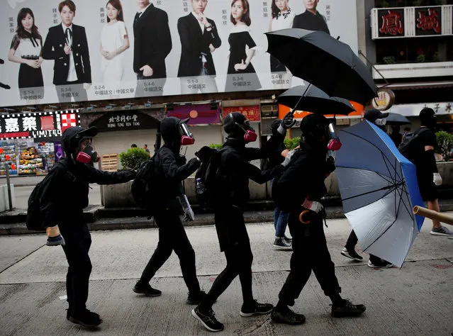 Anti-government demonstrators protect themselves with umbrellas during a protest in Hong Kong, China, October 20, 2019. (Photo by Umit Bektas/Reuters)