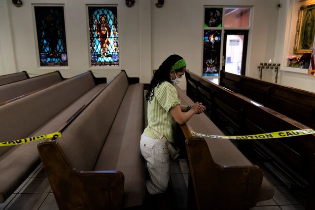 Susana Aguirre prays before the start of a Mass as some pews are taped off for social distancing at Immaculate Heart of Mary Catholic Church Friday, August 20, 2021, in Somerton, Ariz. (Photo by Jae C. Hong/AP Photo)