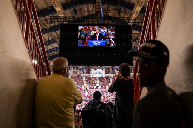 Attendees watch former US President and 2024 Republican presidential candidate Donald Trump speak at a campaign rally at the New Holland Arena in Harrisburg, Pennsylvania, on July 31, 2024. (Photo by Joe Lamberti/AFP Photo)