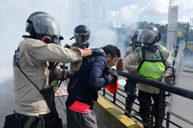 Riot police officers grab an opposition supporter during clashes at a rally against Venezuela's President Nicolas Maduro in Caracas, Venezuela May 20, 2017. (Photo by Carlos Garcia Rawlins/Reuters)