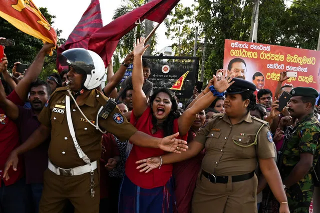 Supporters of Sri Lanka's President-elect Gotabaya Rajapaksa shout slogans as he leaves the election commission office in Colombo on November 17, 2019. Gotabaya Rajapaksa, who spearheaded the brutal crushing of the Tamil Tigers 10 years ago, stormed to victory on November 17 in Sri Lanka's presidential elections, seven months after Islamist extremist attacks killed 269 people. (Photo by Lakruwan Wanniarachchi/AFP Photo)