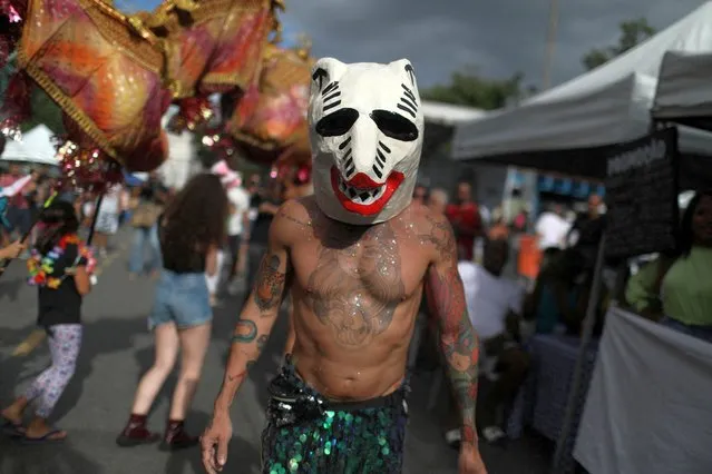 A reveller participates in the annual block party known as “Cordao de Boitata”, ahead of carnival festivities in Rio de Janeiro, Brazil on April 17, 2022. (Photo by Pilar Olivares/Reuters)
