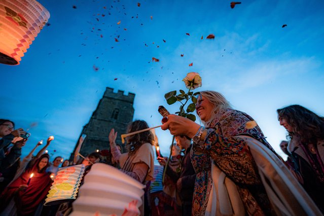 Petals are thrown into the air on the pilgrimage of light, during the Sacred Magdalene Festival at Glastonbury Tor, Somerset, UK which marks the feast day of St Mary Magdelene on Sunday, July 21, 2024. (Photo by Ben Birchall/PA Images via Getty Images)