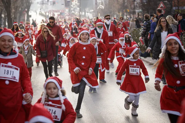 Participants wearing Santa Claus costumes take part in a charity run in Pristina, Kosovo, 15 December 2019. Kosovo's catholic believers celebrate Christmas according to the Gregorian calendar on 25 December. (Photo by Valdrin Xhemaj/EPA/EFE)