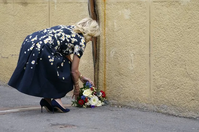 First lady Jill Biden places flowers at a memorial in Bratislava, Slovakia, Saturday, May 7, 2022, that is dedicated to the 26-year-old investigative journalist Jan Kuciak and his fiancée Martina Kusnirova, who were assassinated in their home in 2018. Kuciak had been investigating possible government corruption when he was killed. The killings prompted major street protests unseen since the 1989 Velvet Revolution in Czechoslovakia and a political crisis that led to the government's collapse. (Photo by Susan Walsh/AP Photo/Pool)