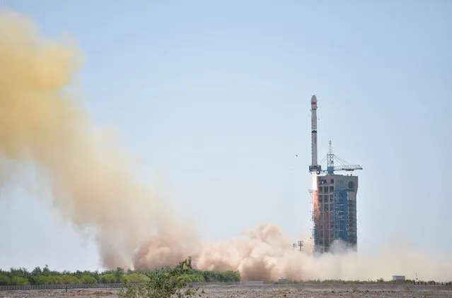 A Long March-4B rocket carrying a 2.5-tonne telescope lifts off from the Jiuquan Satellite Launch Center in northwest China's Gobi Desert on June 15, 2017. China successfully launched on June 15 its first X-ray space telescope, named Insight, to study black holes, pulsars and gamma-ray bursts, state media reported. (Photo by AFP Photo/Stringer)
