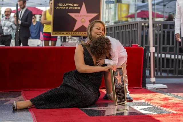 Recording artist Mariah Carey poses on her star with her son Moroccan Scott after it was unveiled on the Hollywood Walk of Fame in Los Angeles, California August 5, 2015. (Photo by Mario Anzuoni/Reuters)