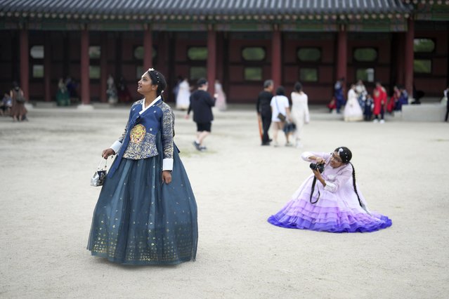 Shithi Tabassum, right, and Naher Tanzila, left, from Bangladesh, dressed in South Korean traditional “Hanbok” attire, pose for their souvenir photos at the Gyeongbok Palace, one of South Korea's well-known landmarks, during the Chuseok holidays, the Korean version of Thanksgiving Day, in Seoul, South Korea, Tuesday, September 17, 2024. (Photo by Lee Jin-man/AP Photo)