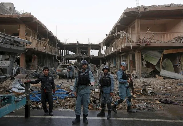Afghan policemen stand guard at the site of a suicide truck bomb in Kabul, Afghanistan August 7, 2015. The truck bomb exploded near an army compound in the centre of the Afghan capital on Friday, killing at least eight people and wounding close to 200, police and health ministry officials said. (Photo by Omar Sobhani/Reuters)