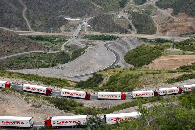 Armenian lorries carriyng humanitarian aid for the Armenian-populated breakaway Nagorno-Karabakh region are seen stranded not far away from an Azerbaijani checkpoint set up at the entry of the Lachin corridor, Karabakh's only land link with Armenia, on July 30, 2023. Karabakh has been at the centre of a decades-long dispute between Armenia and Azerbaijan, which have fought two wars over the mountainous territory. (Photo by Karen Minasyan/AFP Photo)